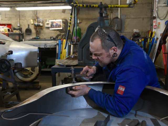 Image showing new wings being hammered into shape.   Image courtesy of Classic & Sports Car magazine.